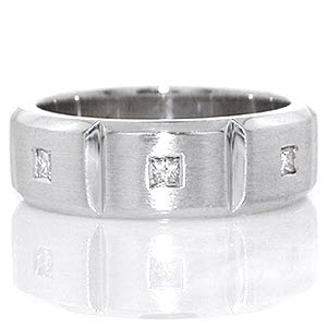 Crafted in 14k white gold, the Manhattan band has a total of 0.24 carats of flush set princess cut diamonds. The diamonds are set into the center of three stations which are separated by high polished grooves. The band has rounded edges for a tailored fit.