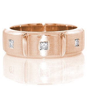 Crafted in 14k white gold, the Manhattan band has a total of 0.24 carats of flush set princess cut diamonds. The diamonds are set into the center of three stations which are separated by high polished grooves. The band has rounded edges for a tailored fit.