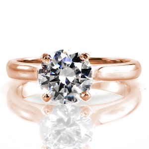 The Contour Solitaire is a stunning and classic ring. A four prong crown gracefully holds a 1.50 carat round brilliant cut diamond. The cathedral style shank emits swopping shoulders that float beneath the center stone. The delicate width of the 14k white gold band is timeless, and radiates with a high polish.  