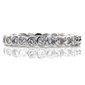 This full bezel diamond eternity band has a modern look and clean lines. With over 0.83 carats of round brilliant diamonds, the design forms a seamless row of sparkle. The band is crafted in 14k white gold with the smooth curves of the bezels and a high polish finish for added comfort and shine.