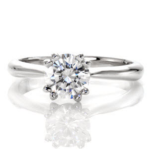Inspiration is truly a vision with its 1.00 carat round brilliant diamond. The double prongs add a sophisticated touch to this timeless center stone. The smooth polished metal of the 14k white gold heightens the luster of the band. Bezel set peek-a-boo diamonds embellish each side of the ring for a decorative accent. 