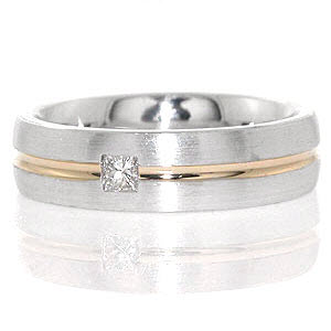This modern and classic band is crafted in 14k white gold with a central inlay of 14k yellow gold. Dual matte and polish finishes further highlight the contrast with the yellow and white gold. A 0.15 carat princess cut diamond is flush set for a luminous focal point. 