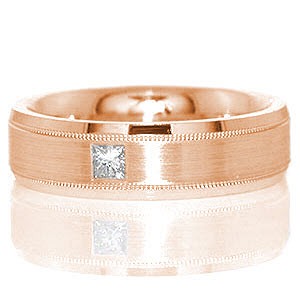 Atlanta is a sophisticated band shown in 14k white gold. A 0.15 carat princess cut diamond is flush set in the middle of the band for appeal. The beveled band is detailed with three textures: high-polished beveled sides, a matte finished middle, and two grooves that have a reversed milgrain texture.