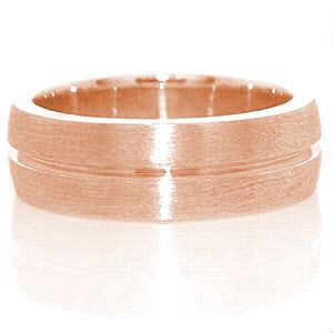 The Jersey band is a prominent design crafted in 14k white gold. The wide presence of the band slightly domes for a well suited fit. A single channel is forged down the band center. The brushed finish to the surface highlights the eternity channel stripe.