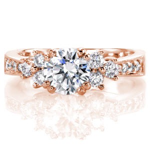 Destiny shimmers from every angle with the radiant display of round brilliant cut diamonds. The 1.00 carat center stone is featured next to a cluster of three stones on each side of the band. Decorated with bead-set diamonds, the tapered band enhances the array of round diamonds near the top of the ring.   