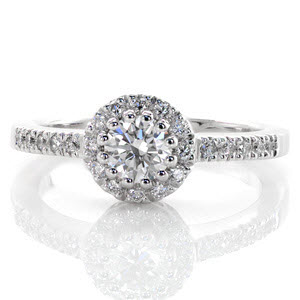 The Classic Halo is a charming design with a unique setting. The 0.50 carat round brilliant cut center diamond is set with twelve prongs to form a decorative circle. The round halo and top of the band are accented with magnificent micro pavé. The rest of the band is finished with a high polish.