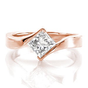 Princess Motion is a contemporary statement with the fashion-forward contour of the the 14k white gold band. The 0.75 carat princess cut diamond is poised elegantly between the by-pass of the ring. A gentle twist of the band seamlessly showcases the brilliant center stone adding movement to the top of the ring.      